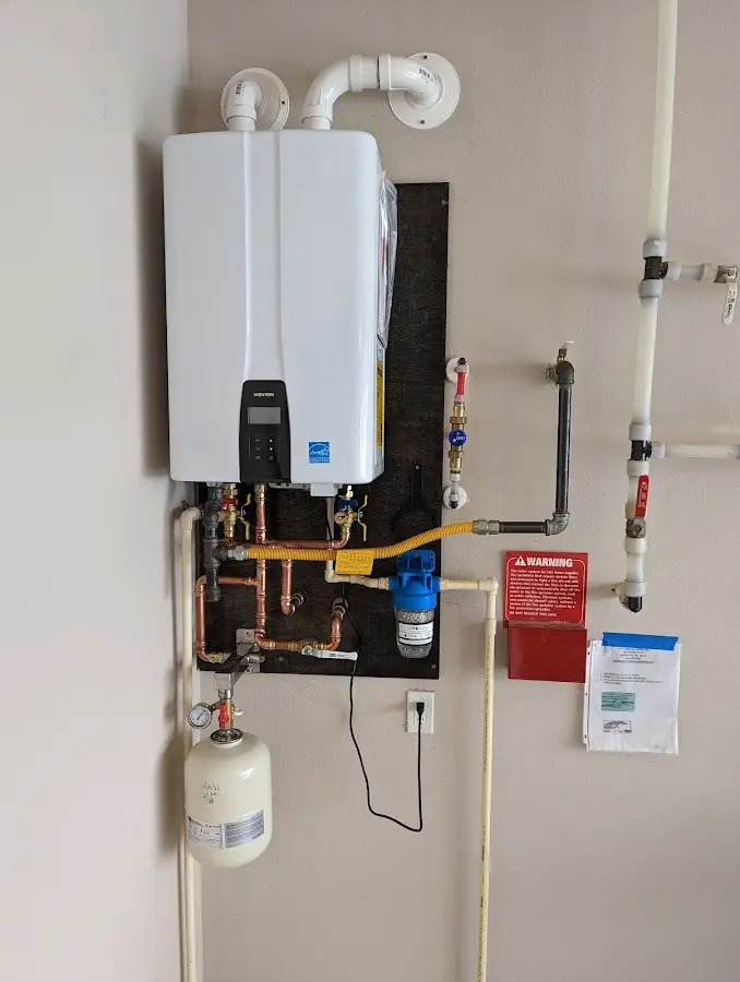 Professional plumber installing copper piping in a West Laurel home
